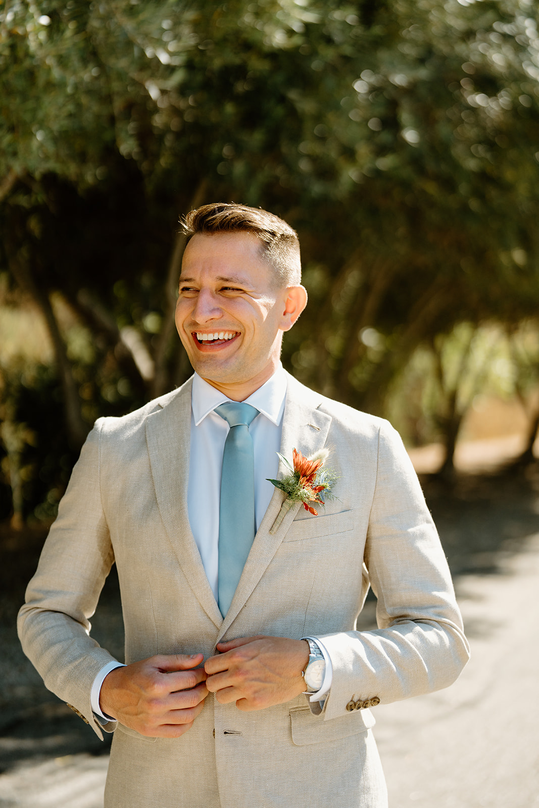 Groom laughing at Higuera Ranch, San Luis Obispo CA, photography by Cobblestone