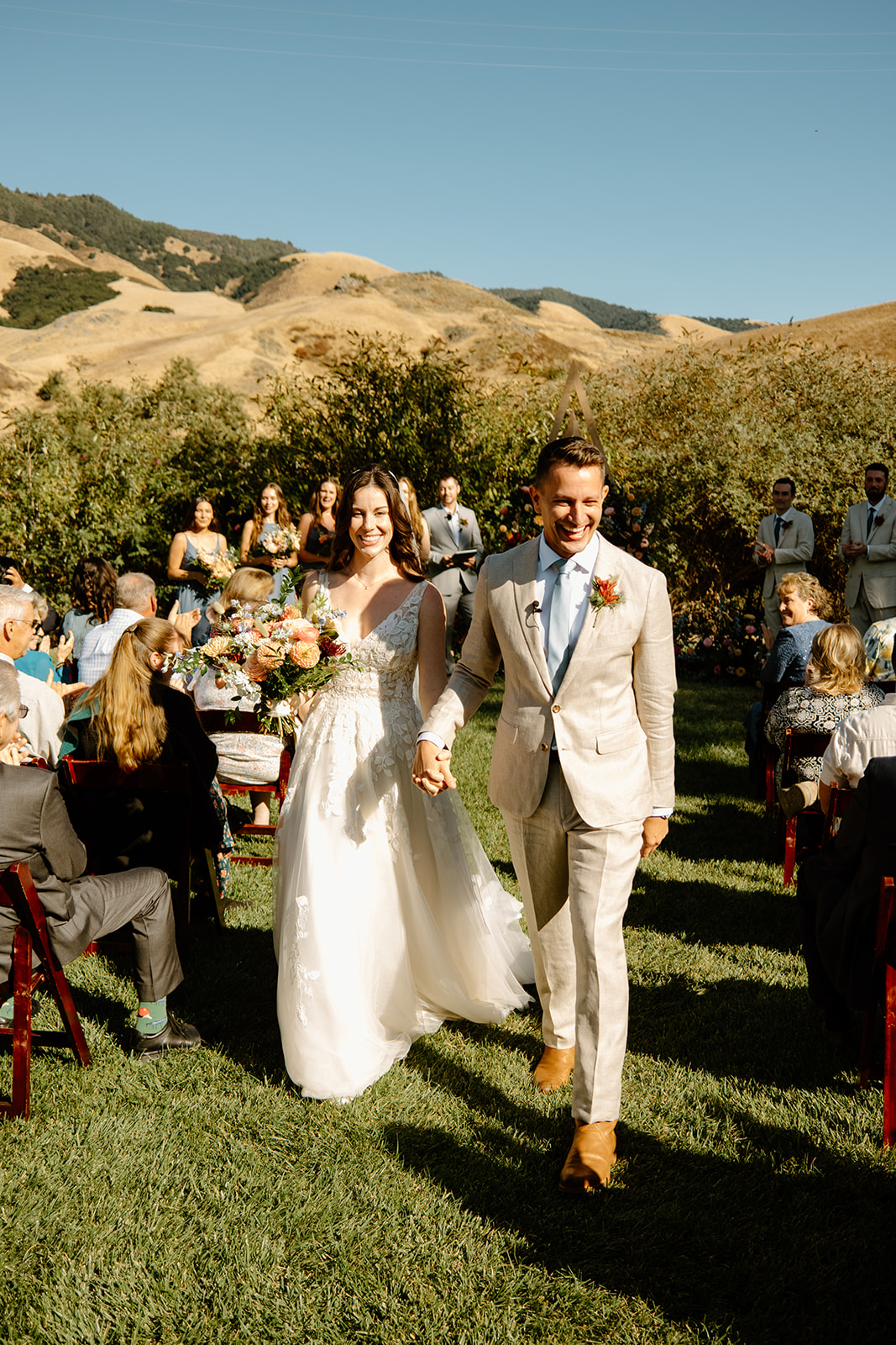 bride and groom walk down the isle at Higuera Ranch, San Luis Obispo CA, photography by Cobblestone