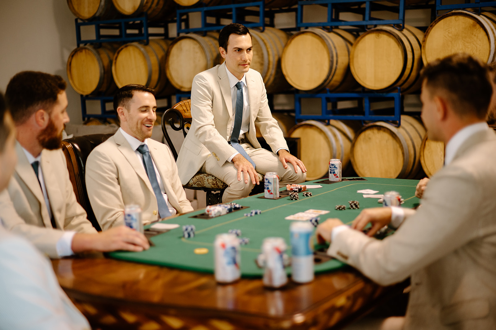 Groomsmen play poker before wedding at Higuera Ranch, San Luis Obispo CA, photography by Cobblestone
