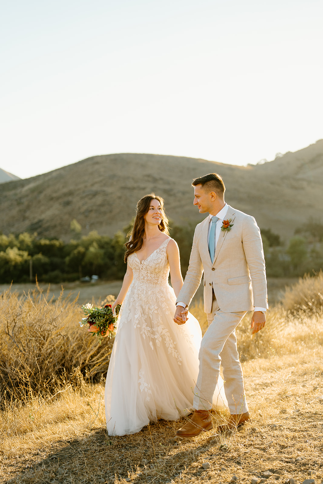 bride and groom walk together at Higuera Ranch, San Luis Obispo CA, photography by Cobblestone