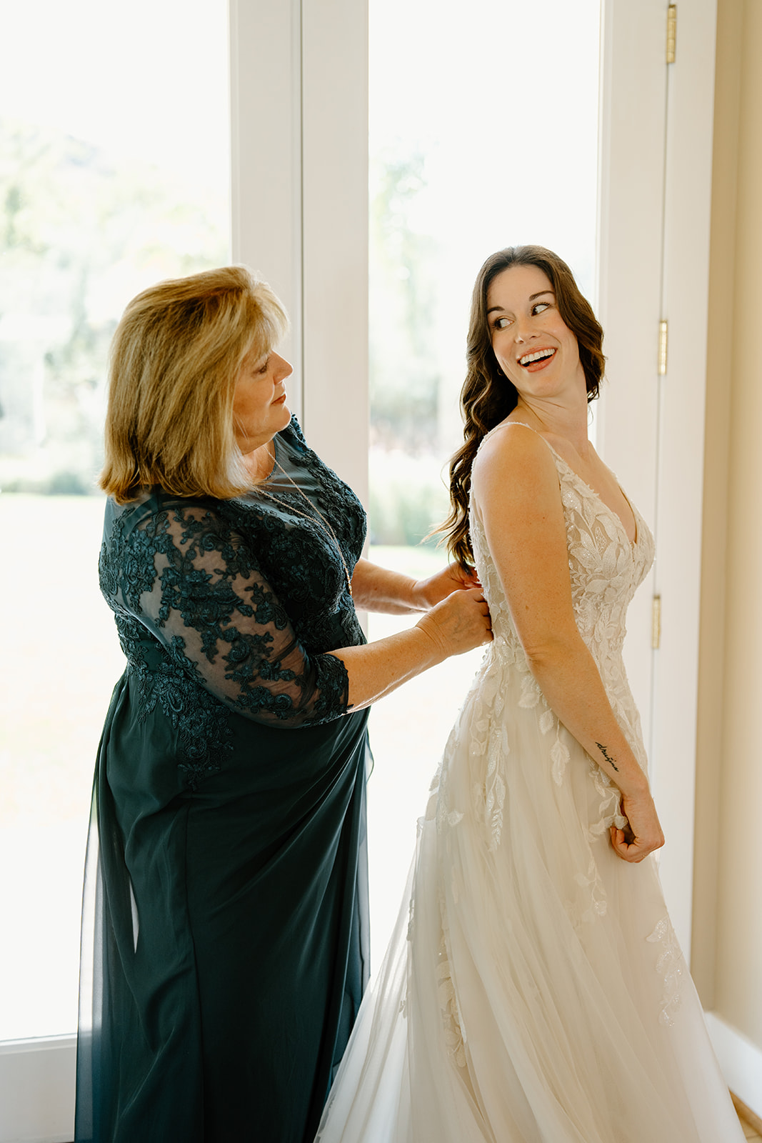 Mother of the bride zips up dress at Higuera Ranch, San Luis Obispo CA, photography by Cobblestone