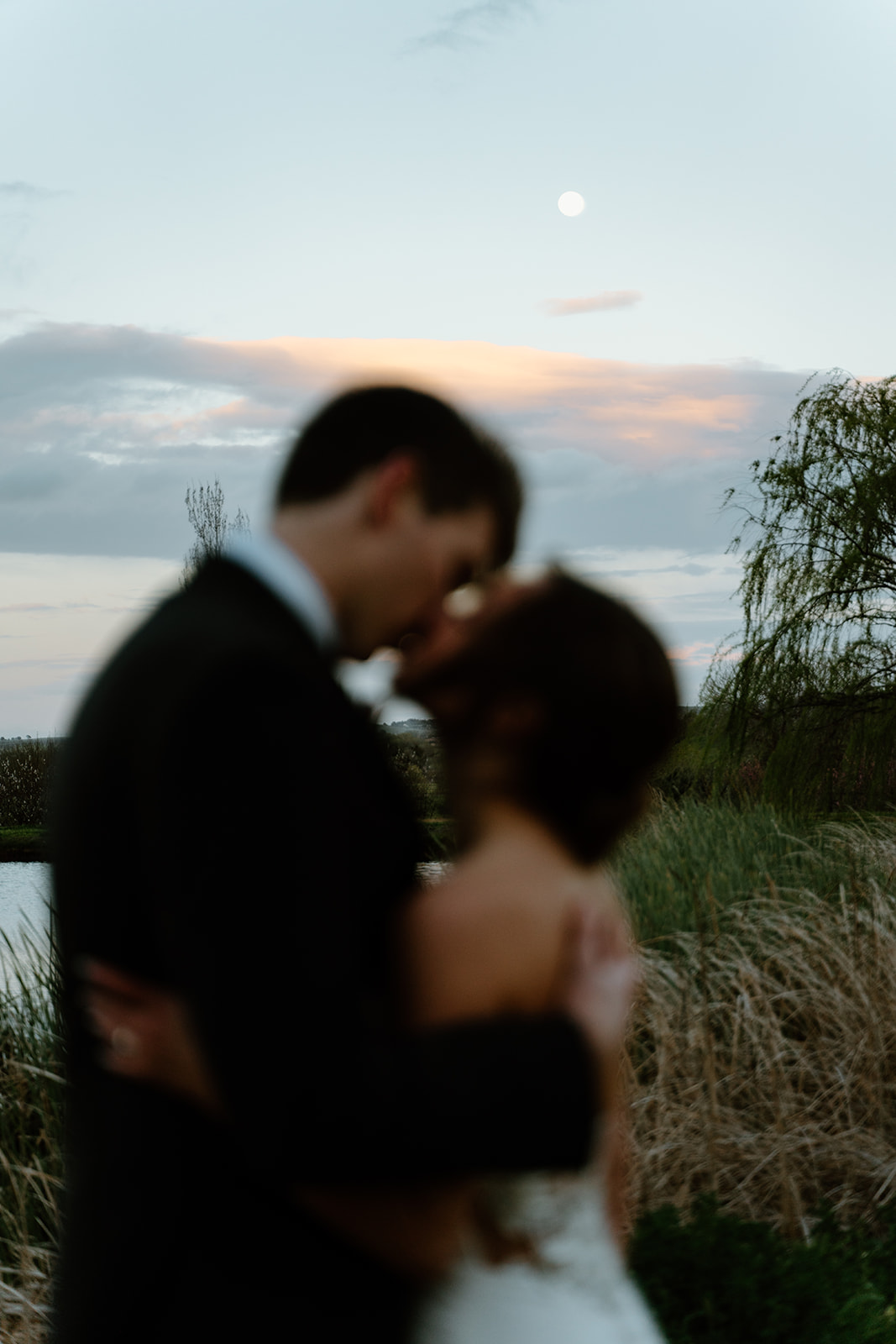 bride and groom look out at moon after wedding in San Luis Obispo CA, photography by Cobblestone