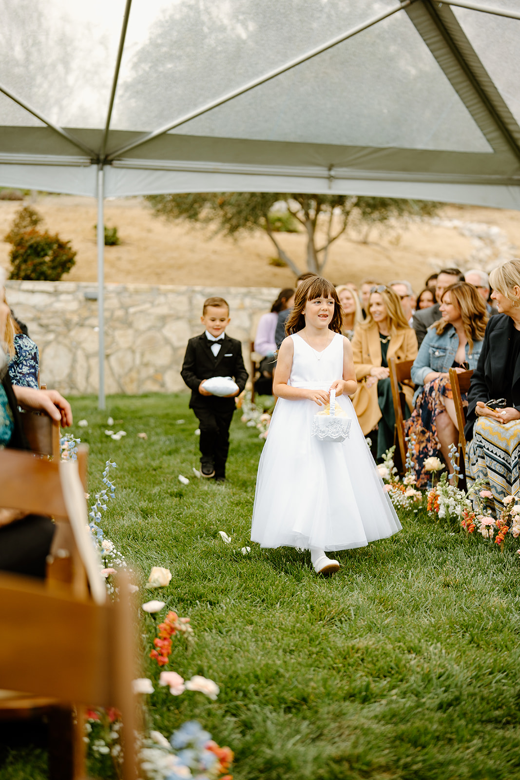 flower girl walks down isle at wedding in San Luis Obispo CA, photography by Cobblestone