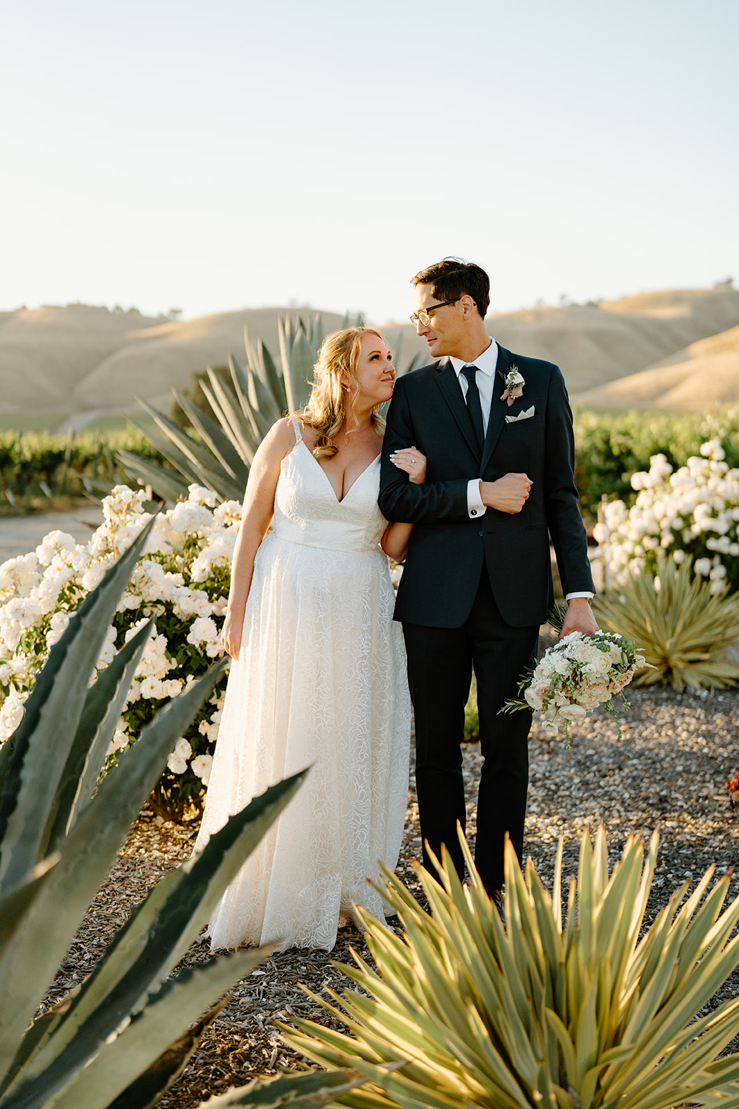 Bride and groom embrace at Cass Windery in Passo Robles CA