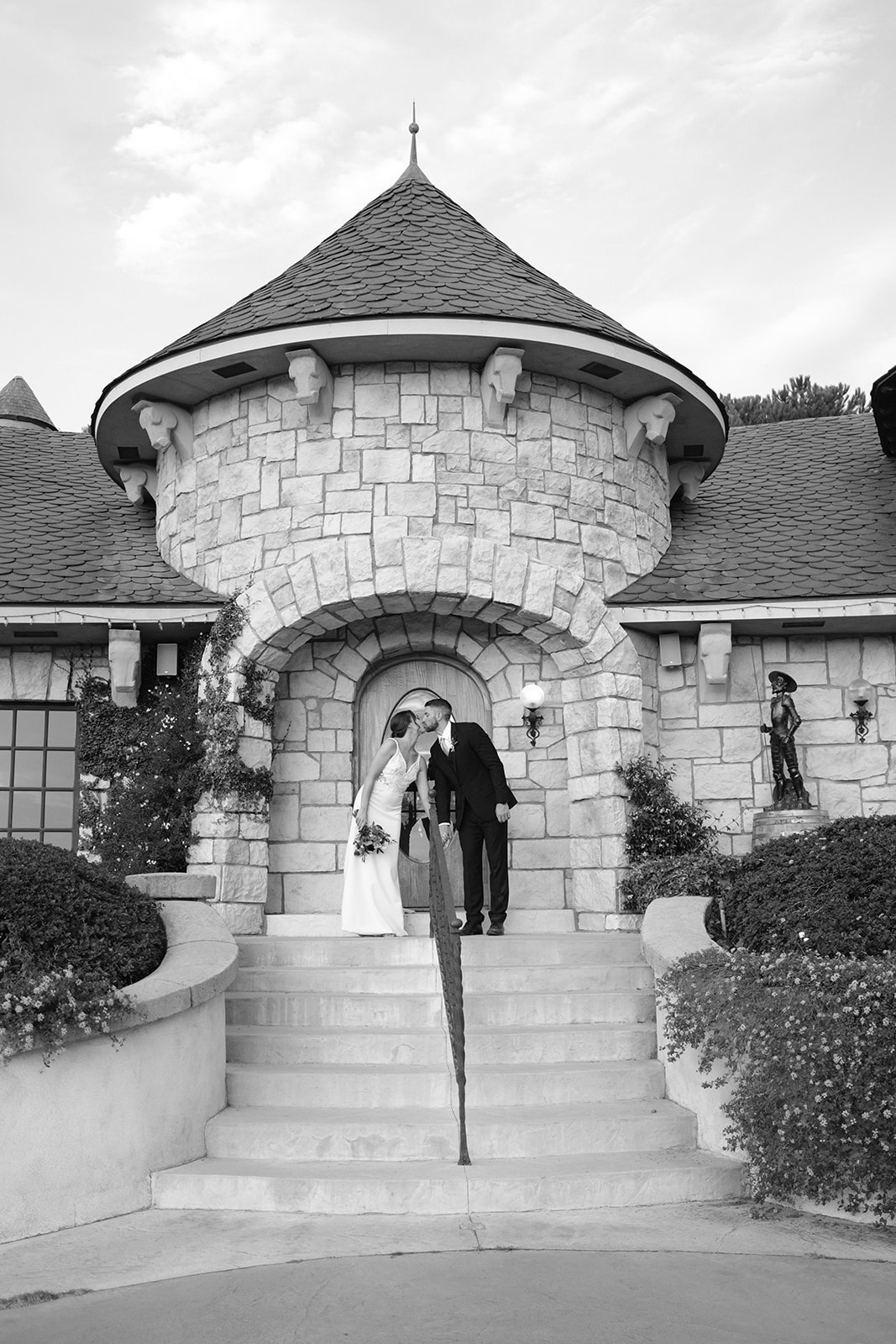 bride and groom kiss at Chateau Noland in San Luis Obispo CA, photography by Cobblestone