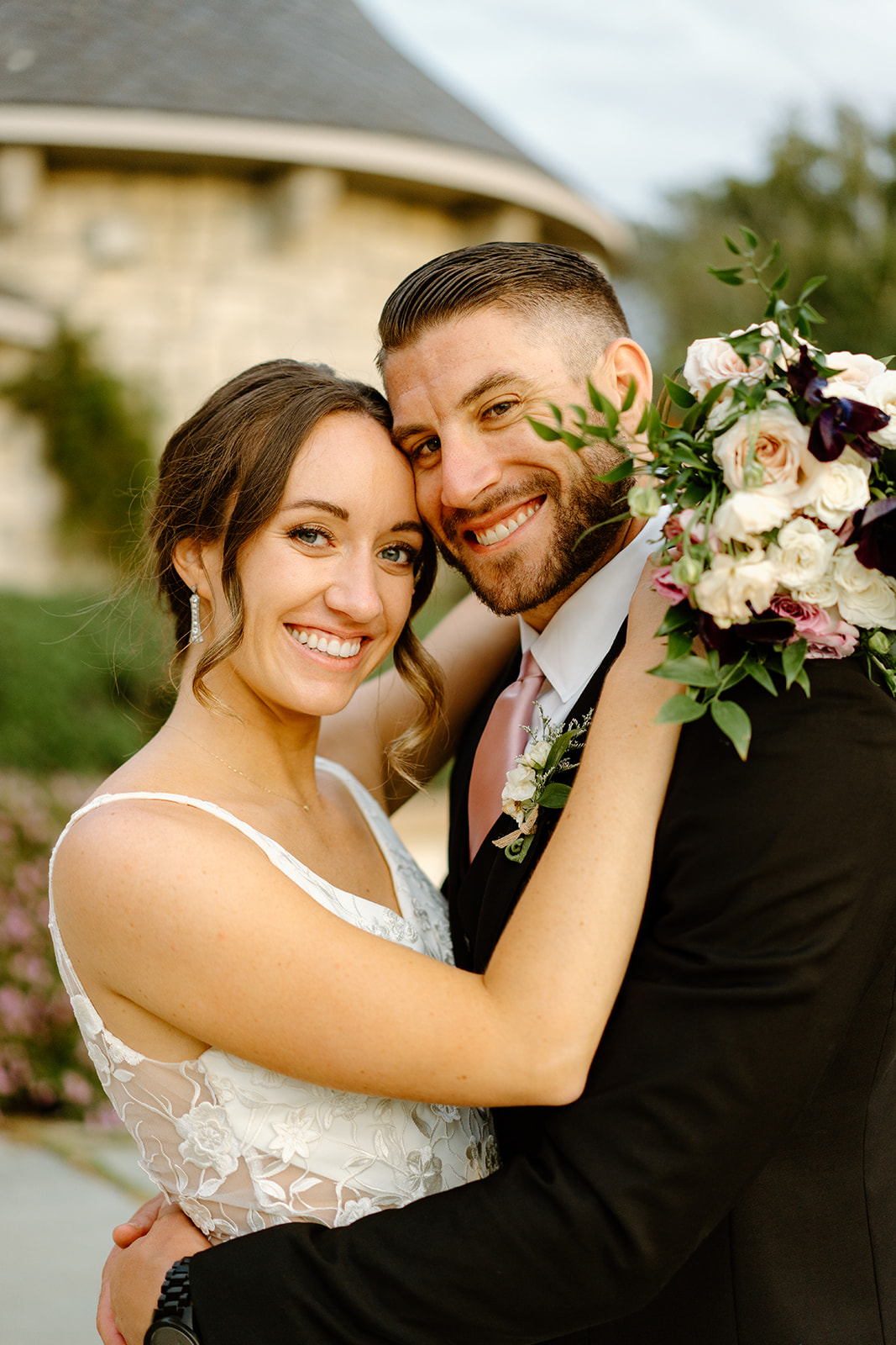 bride and groom hug at Chateau Noland in San Luis Obispo CA, photography by Cobblestone