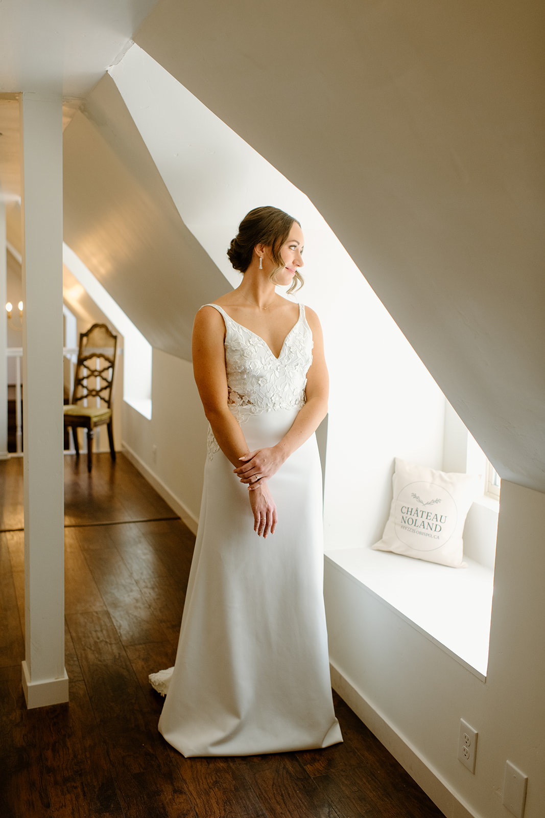 bride looks out window at wedding in San Luis Obispo CA, photography by Cobblestone