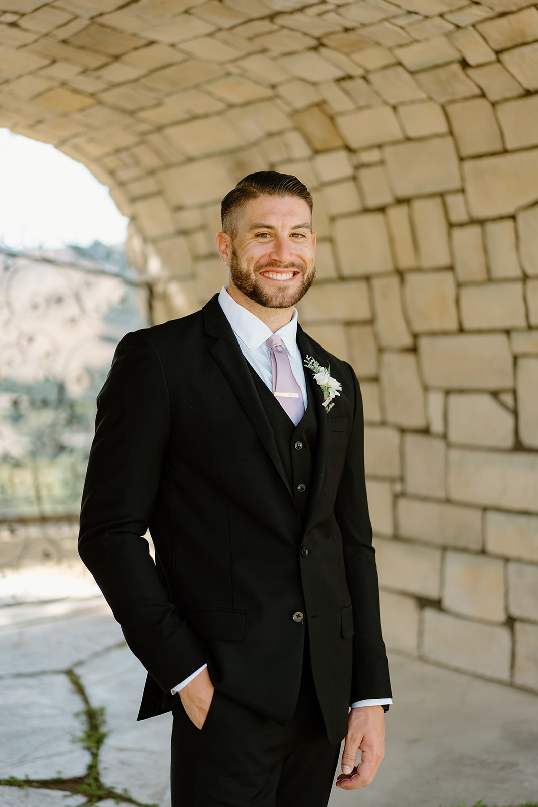groom smiles at Chateau Noland San Luis Obispo California - Cobblestone