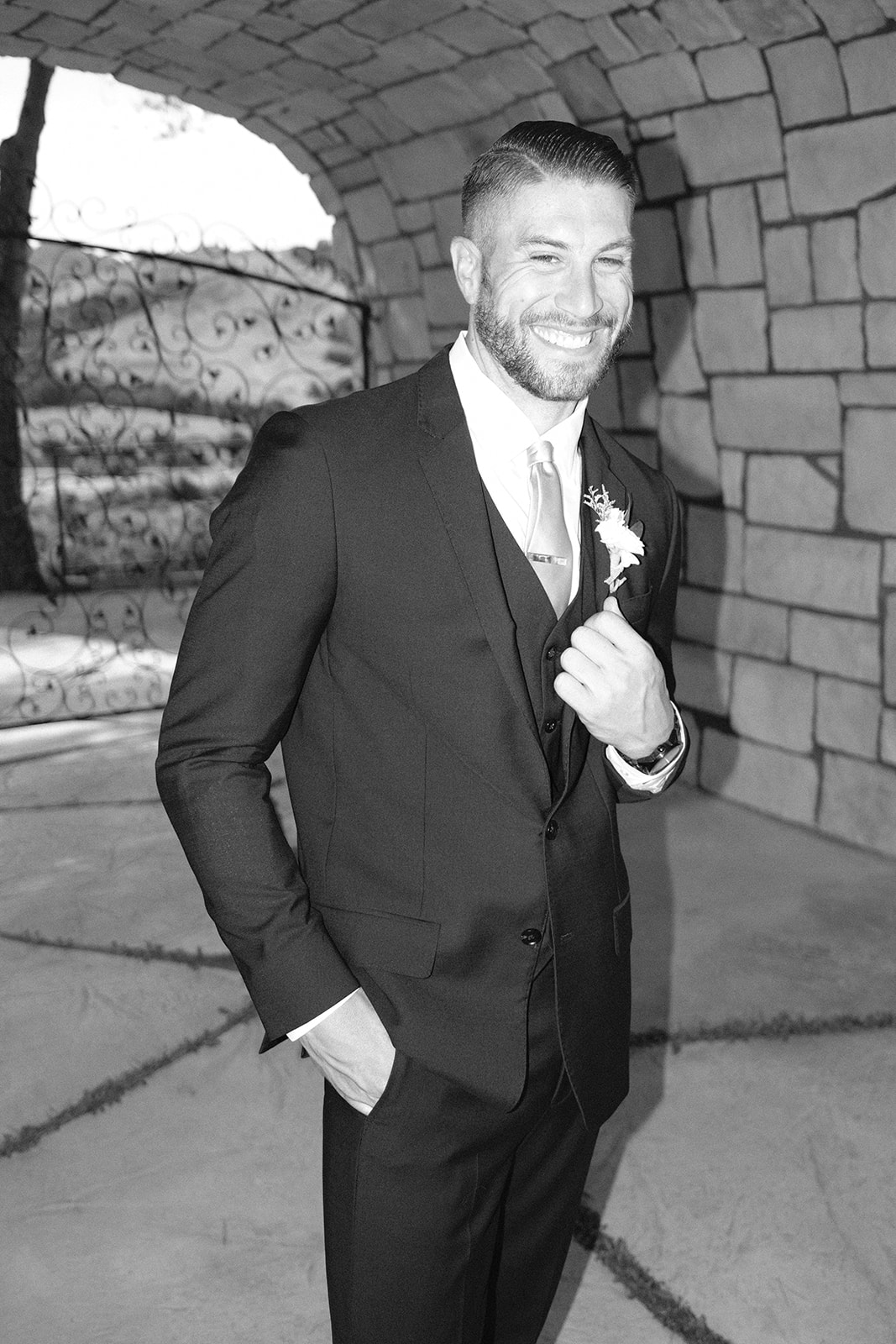 groom smiles at Chateau Noland San Luis Obispo California - Cobblestone