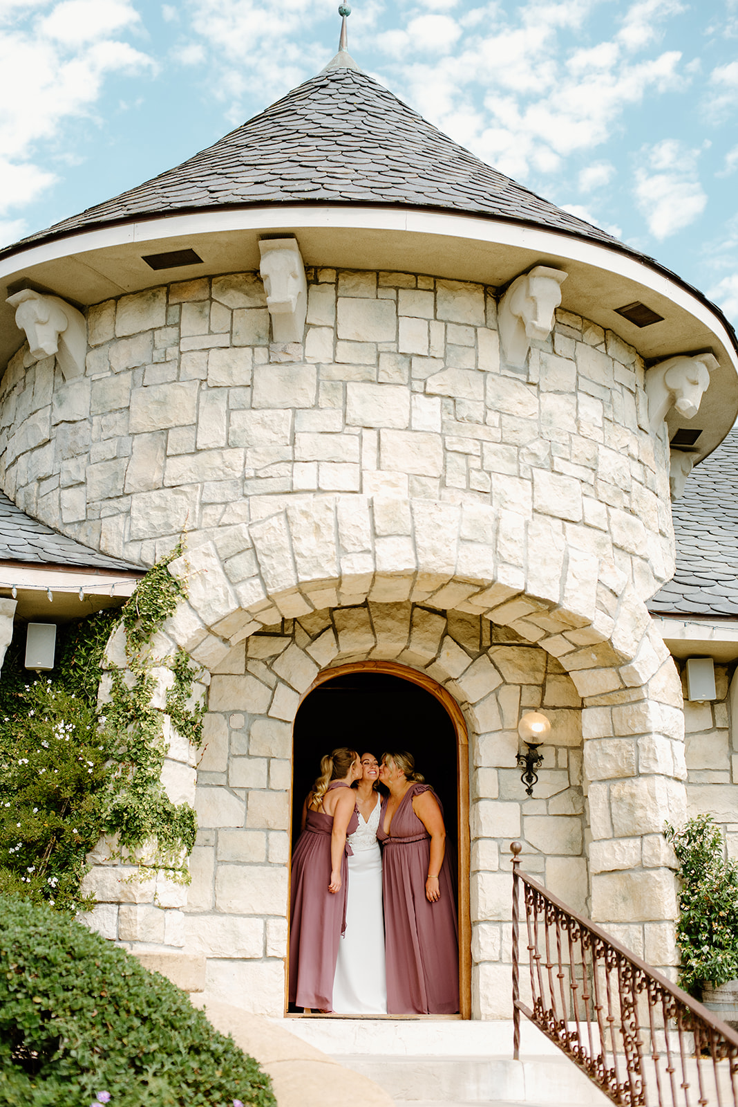 bridesmaids kiss bride at Chateau Noland San Luis Obispo California - Cobblestone