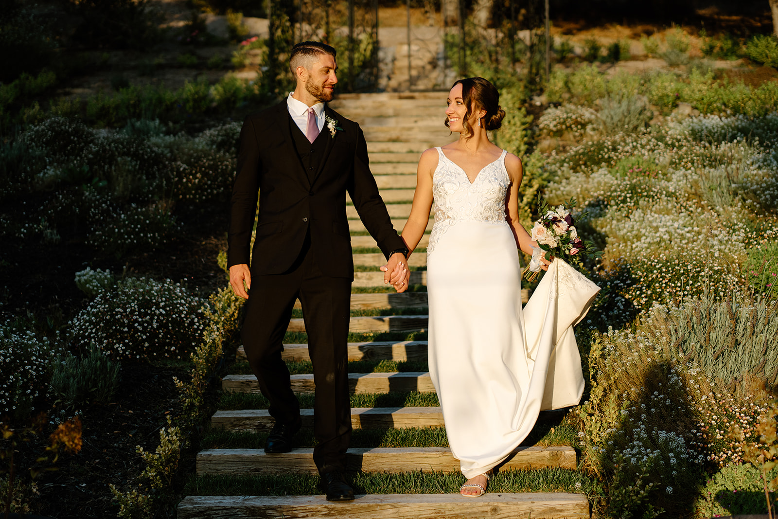 bride and groom pose holding hands after wedding in San Luis Obispo CA, photography by Cobblestone