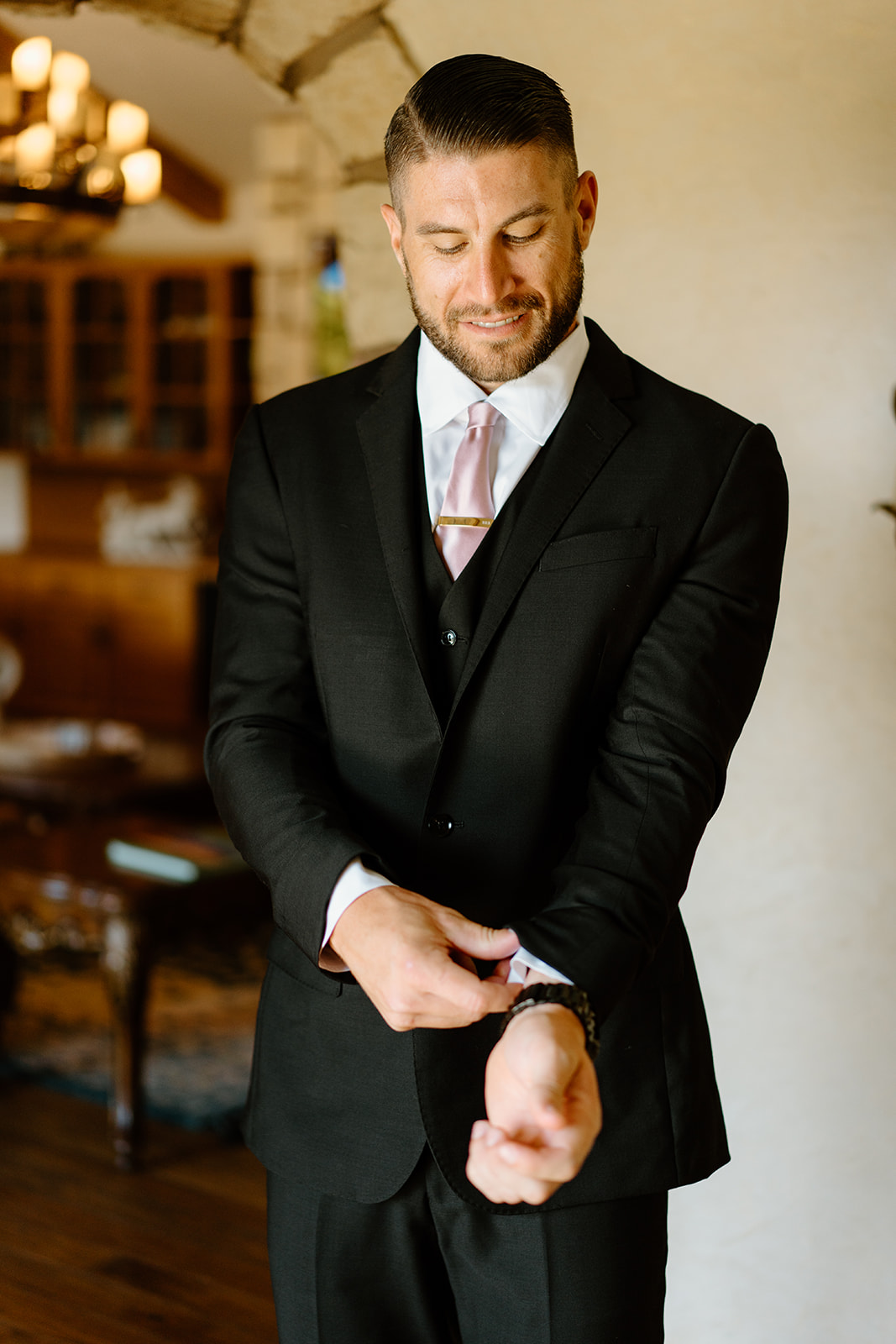 groom details and fixing cuffs at wedding in San Luis Obispo CA, photography by Cobblestone