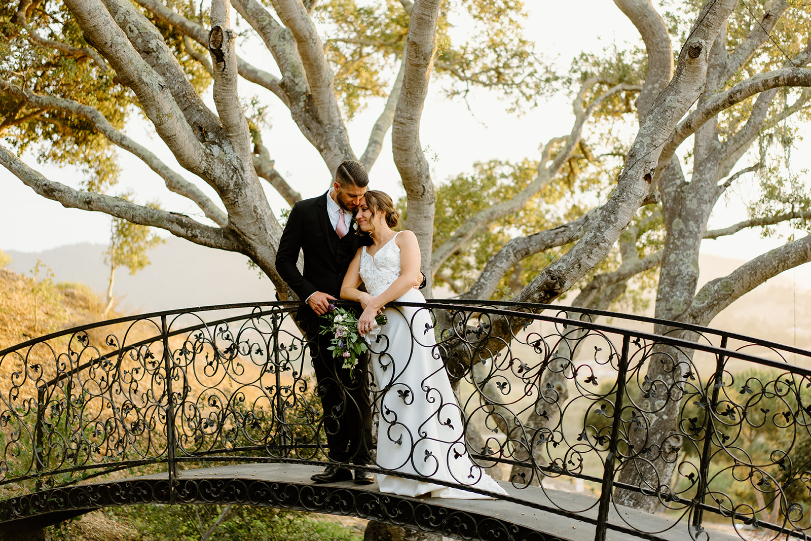 bride and groom on bridge after wedding in San Luis Obispo CA, photography by Cobblestone