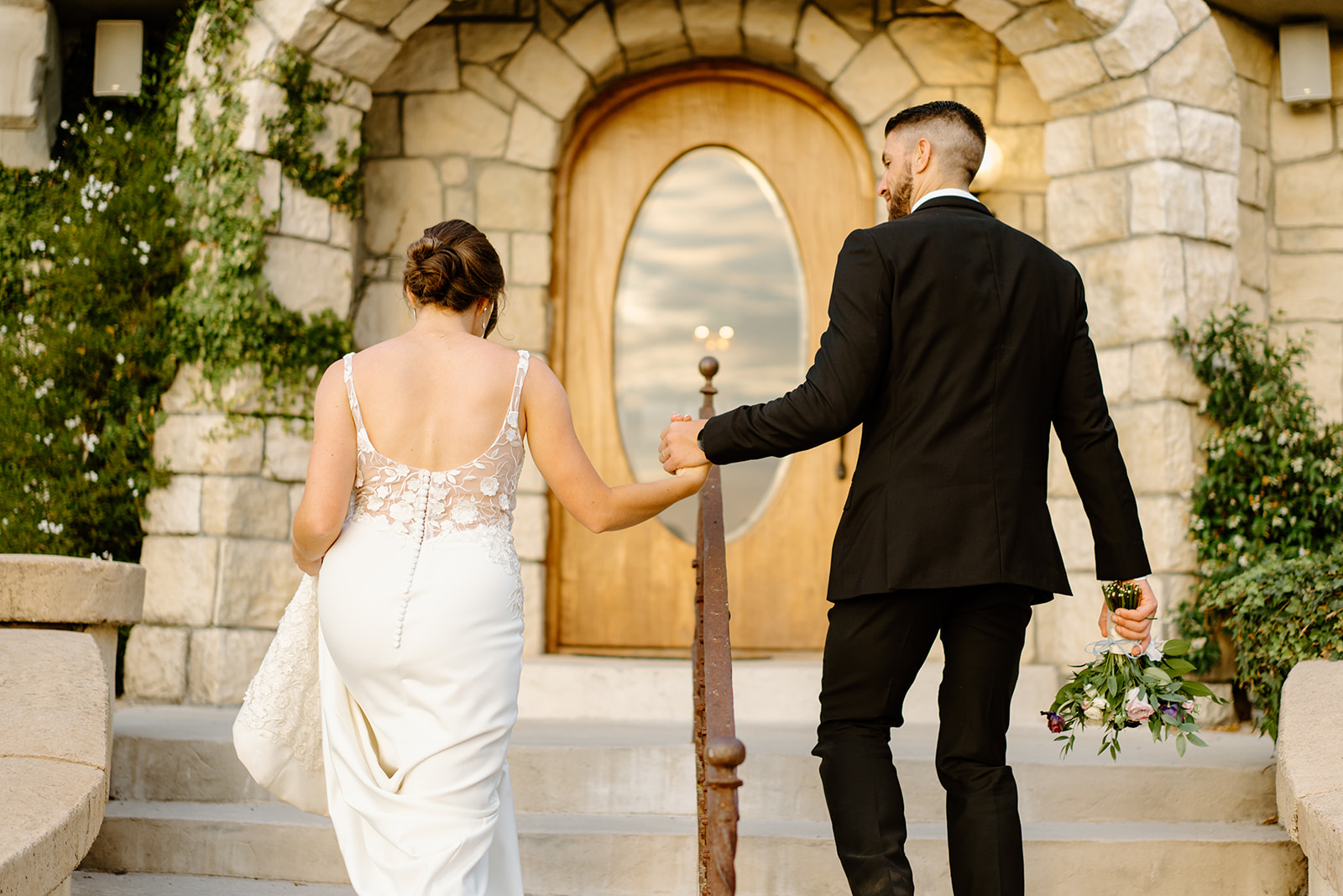 bride and groom walk steps at Chateau Noland in San Luis Obispo CA, photography by Cobblestone