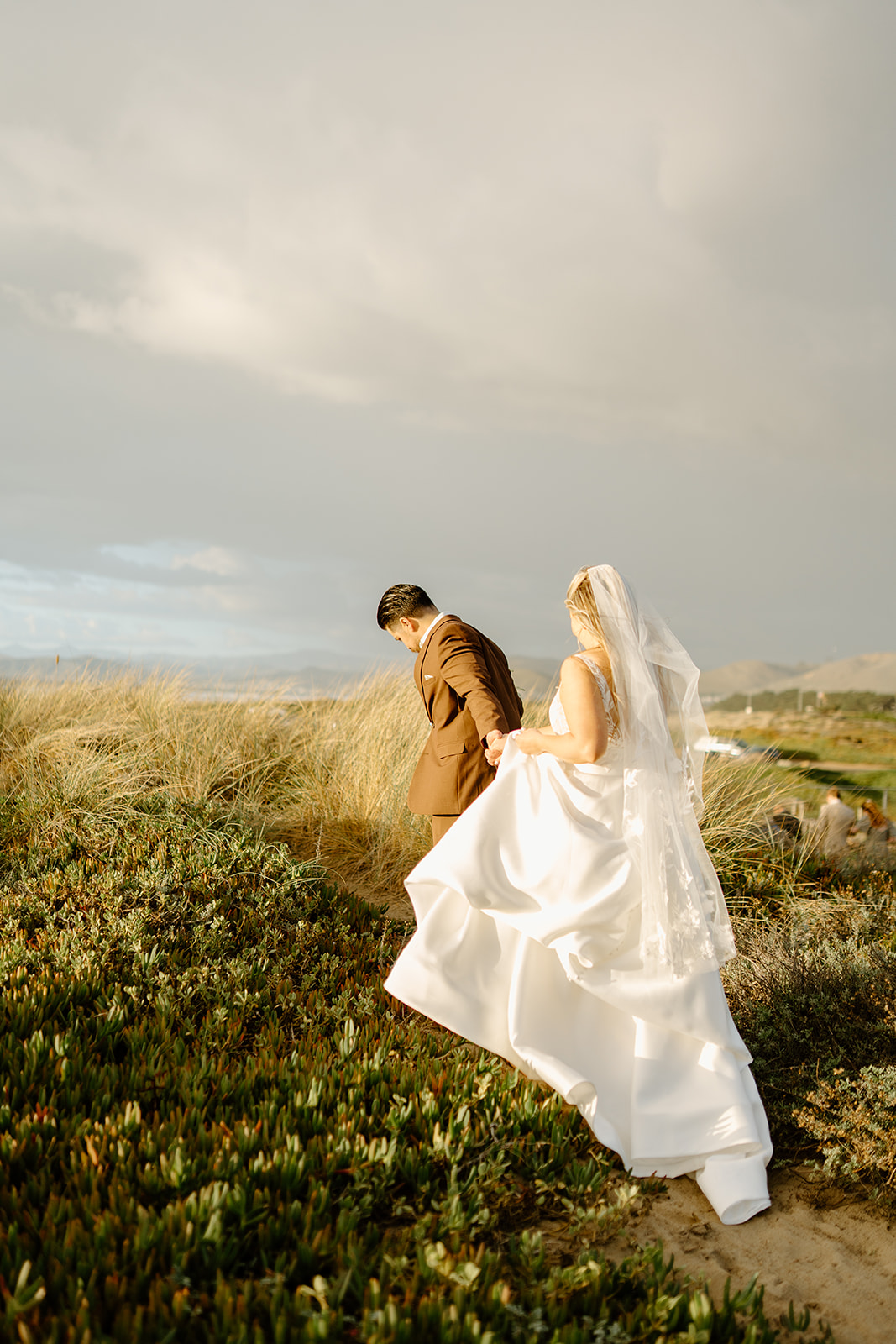 Bride and groom walk bluffs in Morro Bay California, Cobblestone Weddings Photography